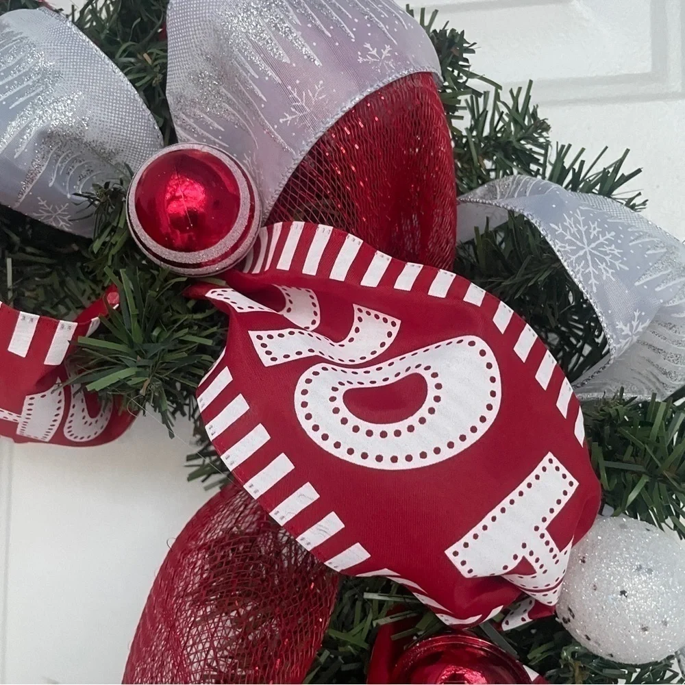 Handmade Christmas wreath, ribbon,bells, and ornaments. Silver, white and red